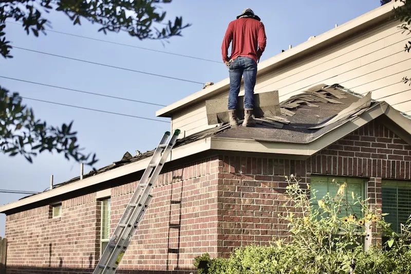 Professional roofer working on a residential roof in Shawnee Village